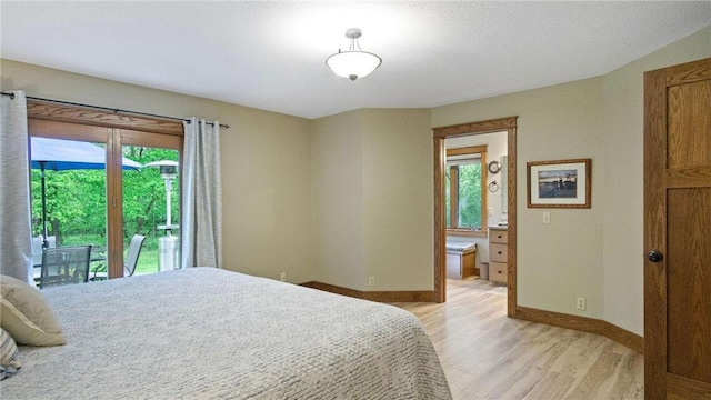 E3313 Jennifer Ln, Eau Claire, WI 54701 - bedroom featuring light wood-style floors, multiple windows, baseboards, and access to exterior