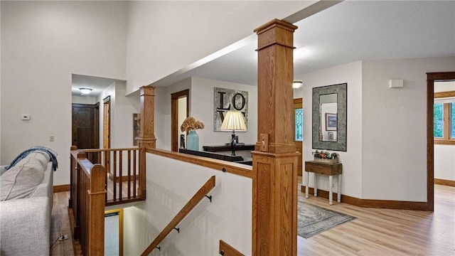 E3313 Jennifer Ln, Eau Claire, WI 54701 - stairs featuring decorative columns, wood finished floors, and baseboards