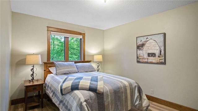 E3313 Jennifer Ln, Eau Claire, WI 54701 - bedroom featuring wood finished floors and baseboards