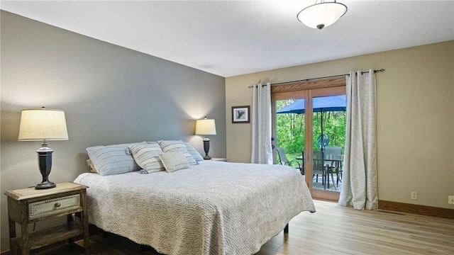 E3313 Jennifer Ln, Eau Claire, WI 54701 - bedroom with wood finished floors, access to outside, and baseboards