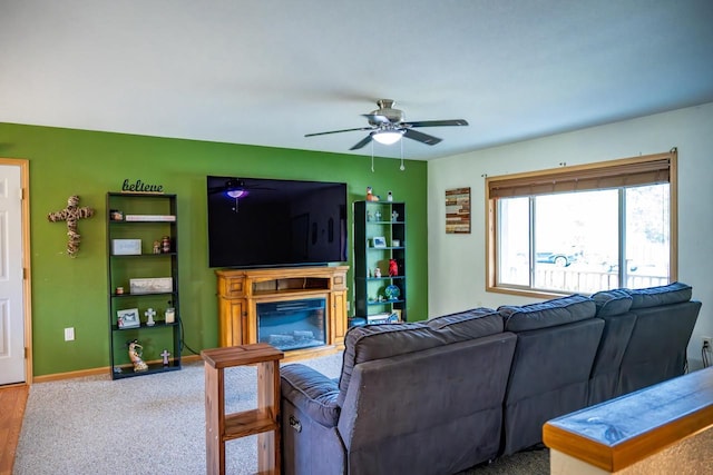 2371 Doris Rd, Reedsburg, WI 53959 - living area with ceiling fan, a glass covered fireplace, and baseboards