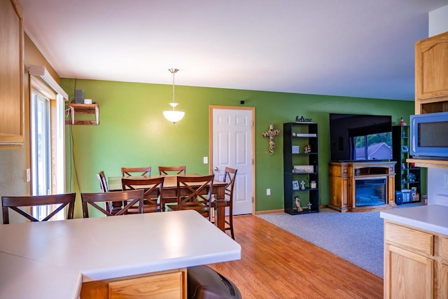 2371 Doris Rd, Reedsburg, WI 53959 - dining area featuring light wood-style flooring, a fireplace, and baseboards