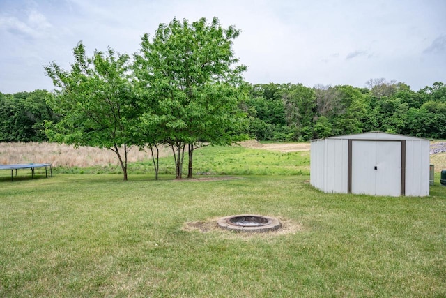2371 Doris Rd, Reedsburg, WI 53959 - view of green lawn featuring a fire pit and a trampoline