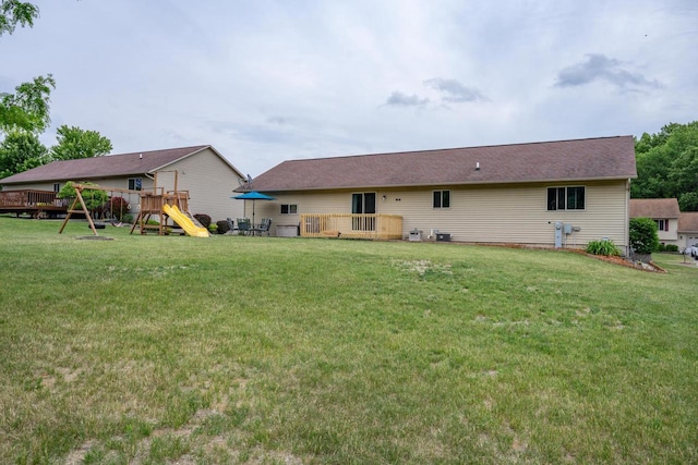 2371 Doris Rd, Reedsburg, WI 53959 - back of property featuring a playground, a deck, and a yard
