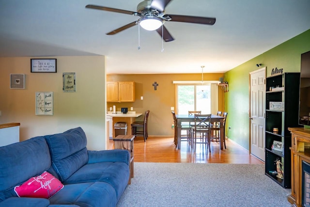 2371 Doris Rd, Reedsburg, WI 53959 - living room with a ceiling fan, light wood finished floors, baseboards, and light colored carpet