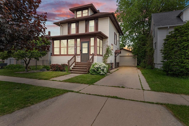 157 E 11th St, Fond Du Lac, WI 54935 - american foursquare style home with an outbuilding, entry steps, a yard, and a detached garage