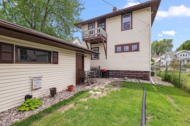 157 E 11th St, Fond Du Lac, WI 54935 - rear view of house with a balcony, a patio, and a chimney