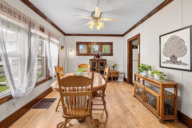 157 E 11th St, Fond Du Lac, WI 54935 - dining space featuring healthy amount of natural light, light wood-style flooring, ornamental molding, and baseboards