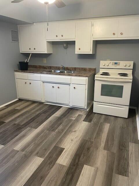 6033 N 61st St Unit 6035, Milwaukee, WI 53218 - kitchen with electric range, a sink, a ceiling fan, white cabinetry, and dark countertops