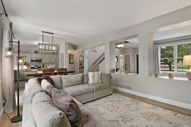 20506 83rd Pl, Bristol, WI 53104 - living area featuring light wood-style floors, baseboards, and stairs