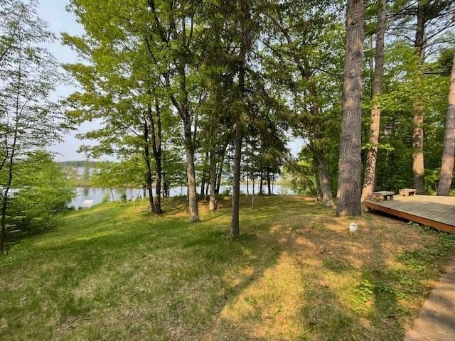 11176 W Plover Ln, Hayward, WI 54843 - view of grassy yard with a deck with water view