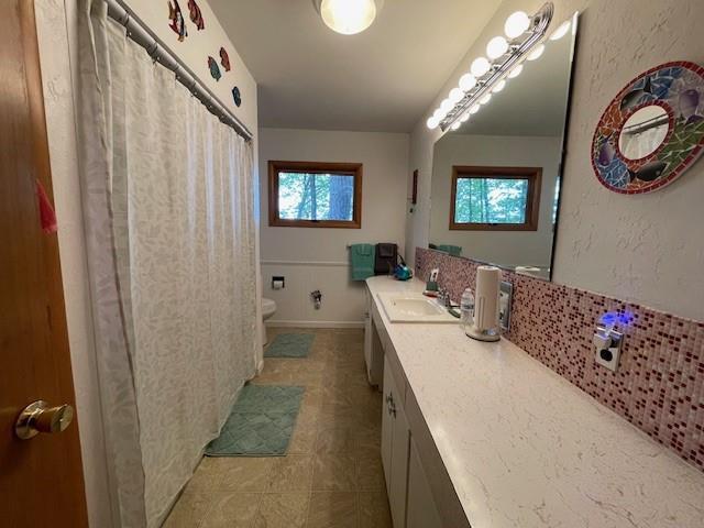 11176 W Plover Ln, Hayward, WI 54843 - full bath featuring vanity, tile patterned flooring, and backsplash