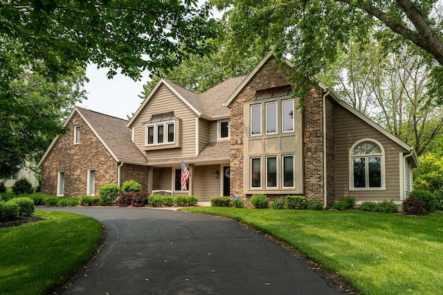 4720 Three Meadows Dr, Brookfield, WI 53005 - view of front facade featuring brick siding, a shingled roof, and a front yard
