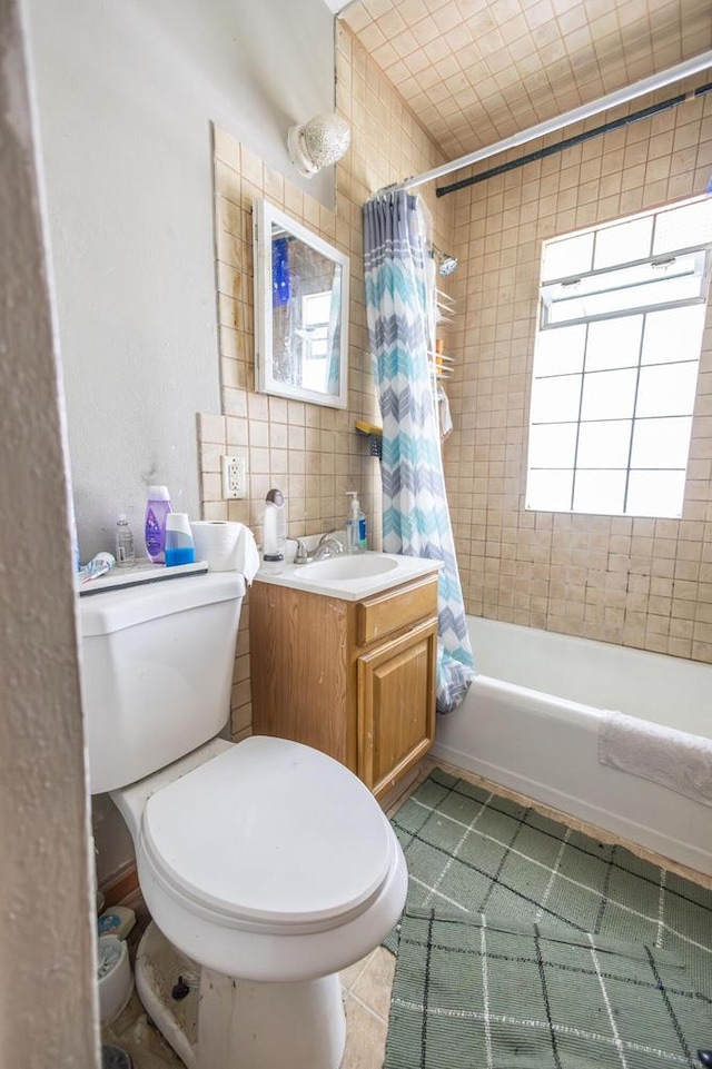 3819 W Douglas Ave, Milwaukee, WI 53209 - bathroom featuring shower / bath combo, healthy amount of natural light, toilet, vanity, and tile walls