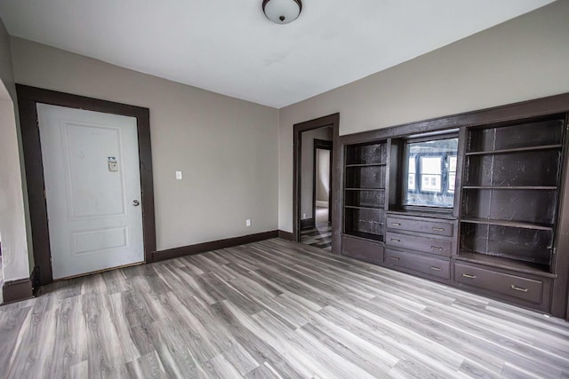 2162 N 41st St Unit 2164, Milwaukee, WI 53208 - unfurnished living room with light wood-type flooring and baseboards