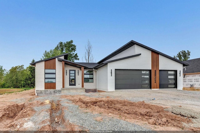 3644 W Hank Ave, De Pere, WI 54115 - view of front of home with an attached garage, brick siding, and driveway