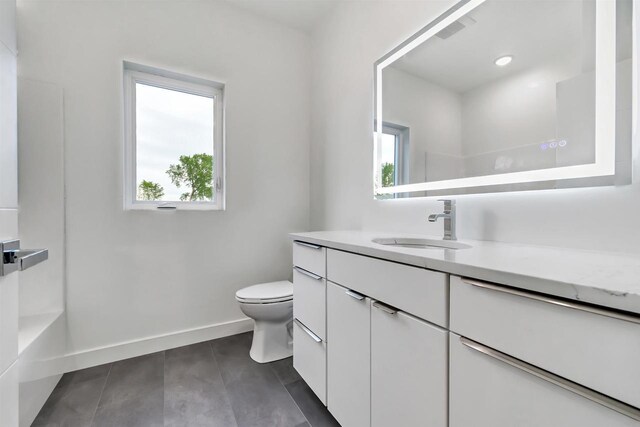 3644 W Hank Ave, De Pere, WI 54115 - bathroom featuring plenty of natural light, vanity, toilet, and baseboards
