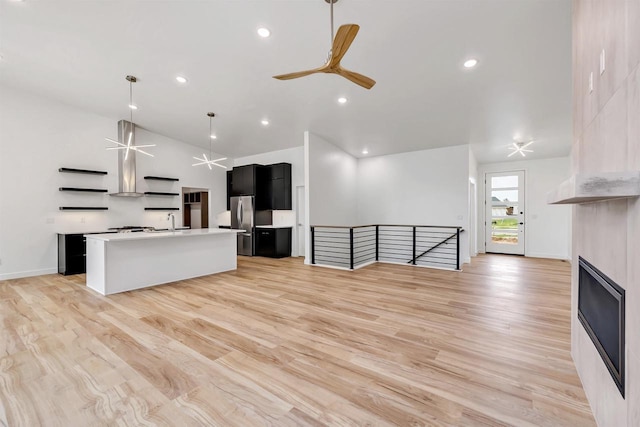3644 W Hank Ave, De Pere, WI 54115 - unfurnished living room featuring ceiling fan, light wood finished floors, recessed lighting, a sink, and baseboards