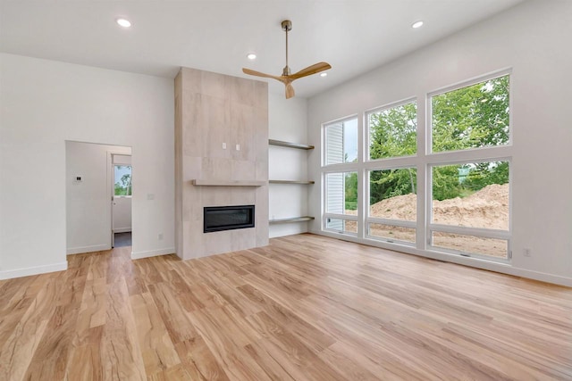 3644 W Hank Ave, De Pere, WI 54115 - unfurnished living room with recessed lighting, light wood finished floors, a fireplace, a ceiling fan, and baseboards