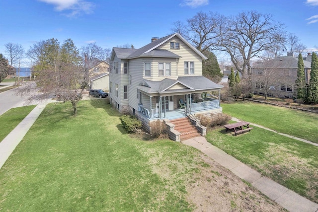 1616 7th St, Menomonie, MI 49858 - victorian home featuring a porch, a chimney, a front lawn, and roof with shingles