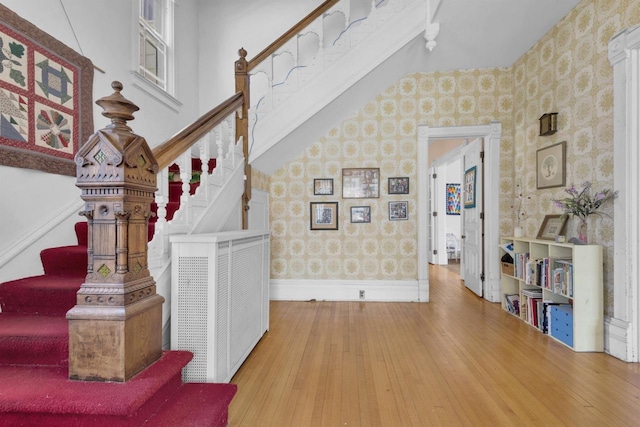 1616 7th St, Menomonie, MI 49858 - stairs with wallpapered walls, baseboards, and hardwood / wood-style floors