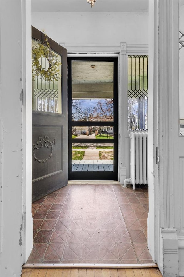 1616 7th St, Menomonie, MI 49858 - foyer entrance featuring radiator heating unit and healthy amount of natural light