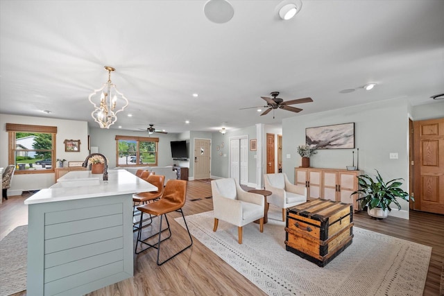 4062 S 106th St, Greenfield, WI 53228 - living room with ceiling fan, light wood finished floors, baseboards, recessed lighting, and a chandelier