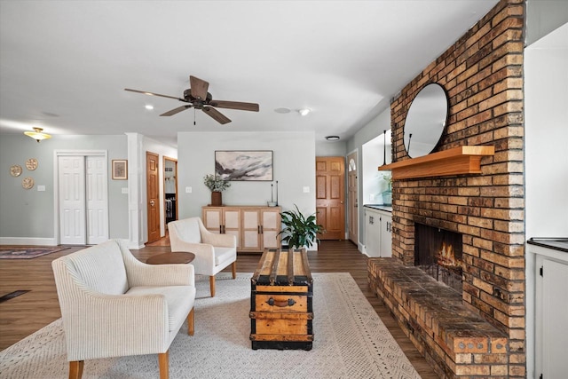 4062 S 106th St, Greenfield, WI 53228 - living room featuring a brick fireplace, wood finished floors, a ceiling fan, baseboards, and recessed lighting