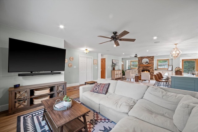 4062 S 106th St, Greenfield, WI 53228 - living room featuring ceiling fan, wood finished floors, baseboards, a fireplace, and recessed lighting