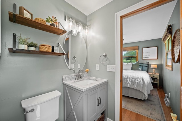 4062 S 106th St, Greenfield, WI 53228 - ensuite bathroom with wood finished floors, vanity, toilet, and baseboards