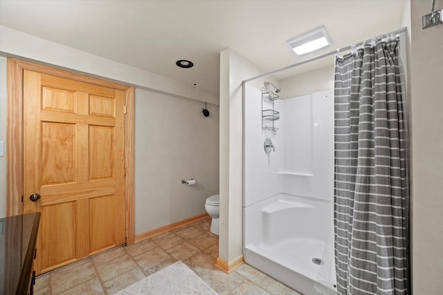 4062 S 106th St, Greenfield, WI 53228 - bathroom featuring toilet, curtained shower, and baseboards