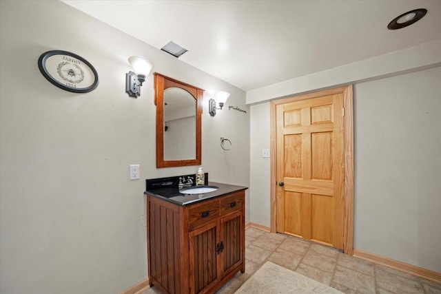 4062 S 106th St, Greenfield, WI 53228 - bathroom featuring vanity, baseboards, and stone finish flooring