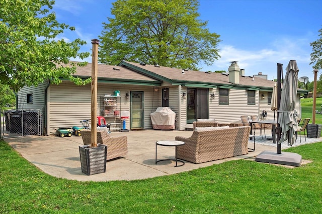 4062 S 106th St, Greenfield, WI 53228 - back of property featuring a patio area, a lawn, and an outdoor living space