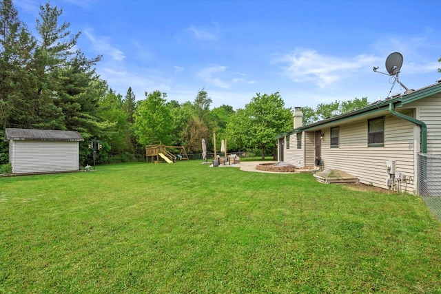 4062 S 106th St, Greenfield, WI 53228 - view of grassy yard featuring a fire pit and a playground
