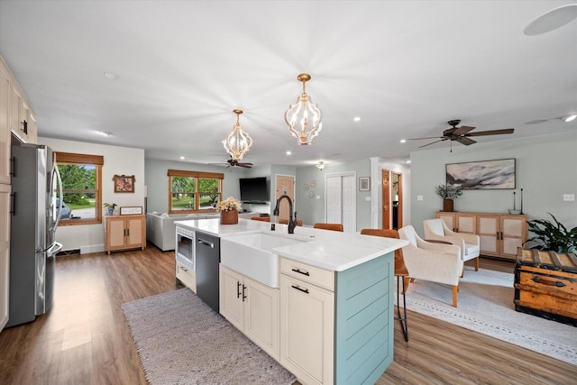 4062 S 106th St, Greenfield, WI 53228 - kitchen with open floor plan, a sink, stainless steel appliances, light wood-style floors, and recessed lighting