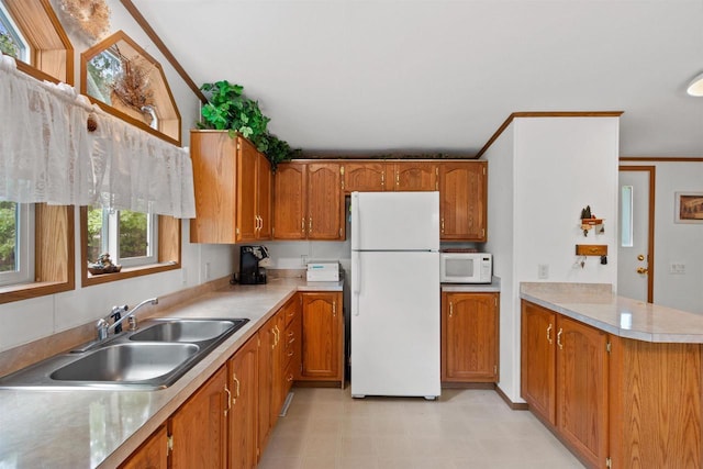 1630 Hawkshead Trl, Nekoosa, WI 54457 - kitchen featuring white appliances, a sink, brown cabinetry, and light countertops