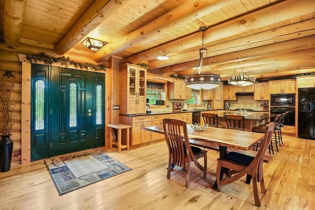 W6034 N Lake Dr, New Lisbon, WI 53950 - dining area featuring light wood-style flooring, wooden ceiling with exposed beams, and rustic walls