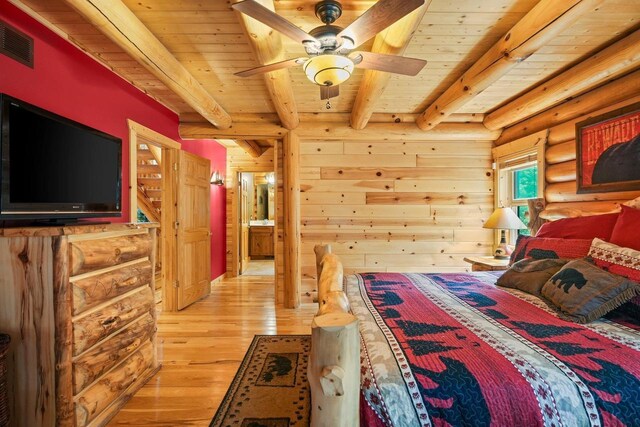 W6034 N Lake Dr, New Lisbon, WI 53950 - bedroom with wooden ceiling with exposed beams, log walls, and light wood-style floors