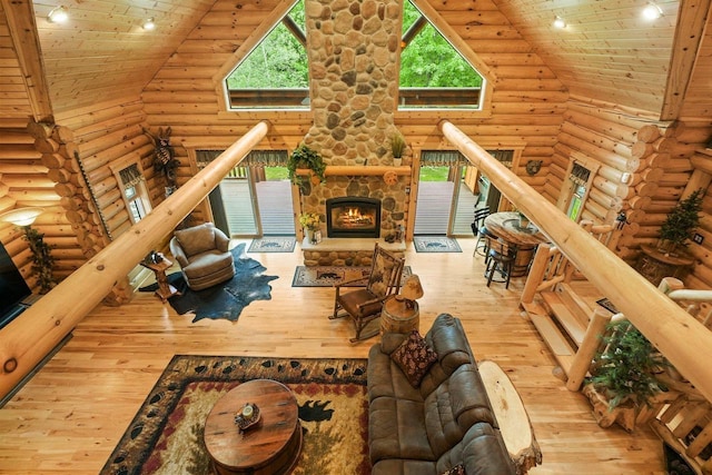 W6034 N Lake Dr, New Lisbon, WI 53950 - living room featuring high vaulted ceiling, wood ceiling, wood-type flooring, log walls, and a fireplace