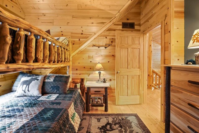 W6034 N Lake Dr, New Lisbon, WI 53950 - bedroom with wood ceiling, wood walls, and hardwood / wood-style floors