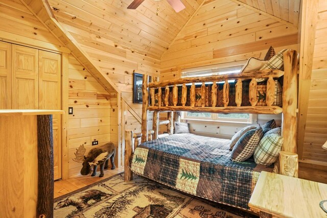W6034 N Lake Dr, New Lisbon, WI 53950 - bedroom featuring lofted ceiling, wood walls, and wooden ceiling