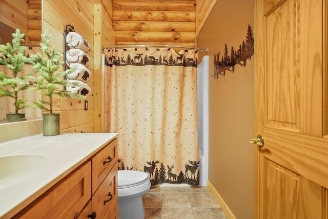 W6034 N Lake Dr, New Lisbon, WI 53950 - bathroom featuring log walls, baseboards, toilet, and vanity