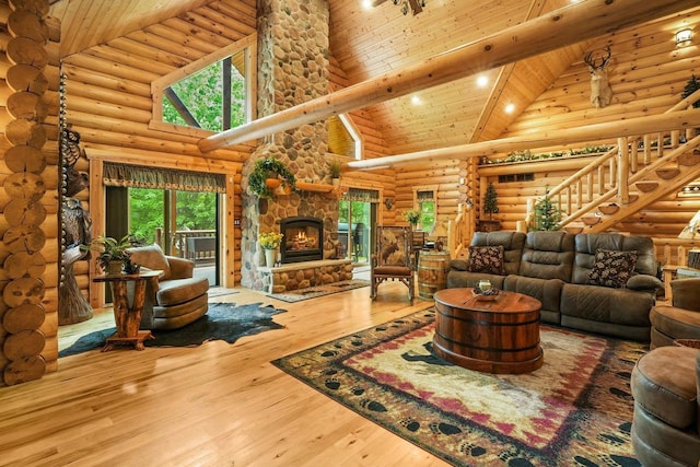 W6034 N Lake Dr, New Lisbon, WI 53950 - living area with high vaulted ceiling, rustic walls, a fireplace, plenty of natural light, and hardwood / wood-style floors