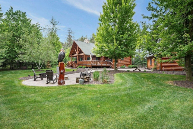 W6034 N Lake Dr, New Lisbon, WI 53950 - view of green lawn featuring a patio, a deck, and a fire pit