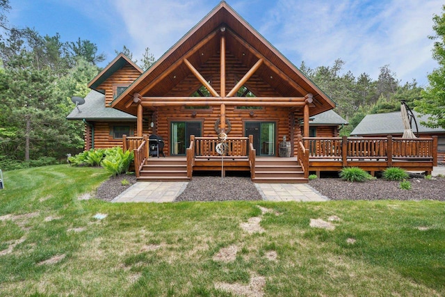 W6034 N Lake Dr, New Lisbon, WI 53950 - back of house featuring log exterior, a yard, and a wooden deck