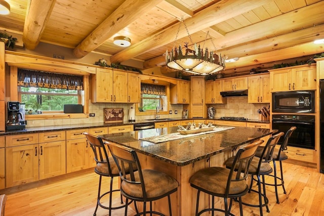 W6034 N Lake Dr, New Lisbon, WI 53950 - kitchen featuring black appliances, under cabinet range hood, light wood-style flooring, wood ceiling with exposed beams, and a kitchen bar