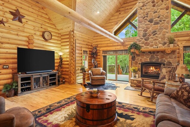 W6034 N Lake Dr, New Lisbon, WI 53950 - living room featuring high vaulted ceiling, wood-type flooring, a fireplace, plenty of natural light, and log walls