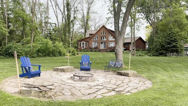 9213 Willow Ln, Fremont, WI 54940 - rear view of house featuring an outdoor fire pit, a patio, a yard, and log exterior
