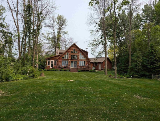 9213 Willow Ln, Fremont, WI 54940 - back of house featuring log exterior, a yard, and a chimney