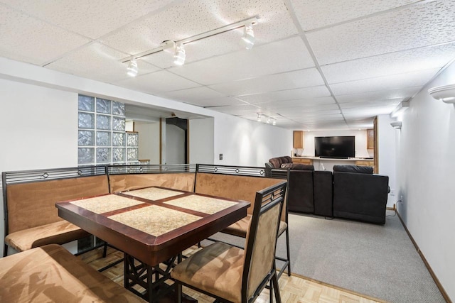109 County Park Rd, Waupun, WI 53963 - dining space with rail lighting, a drop ceiling, baseboards, and light colored carpet